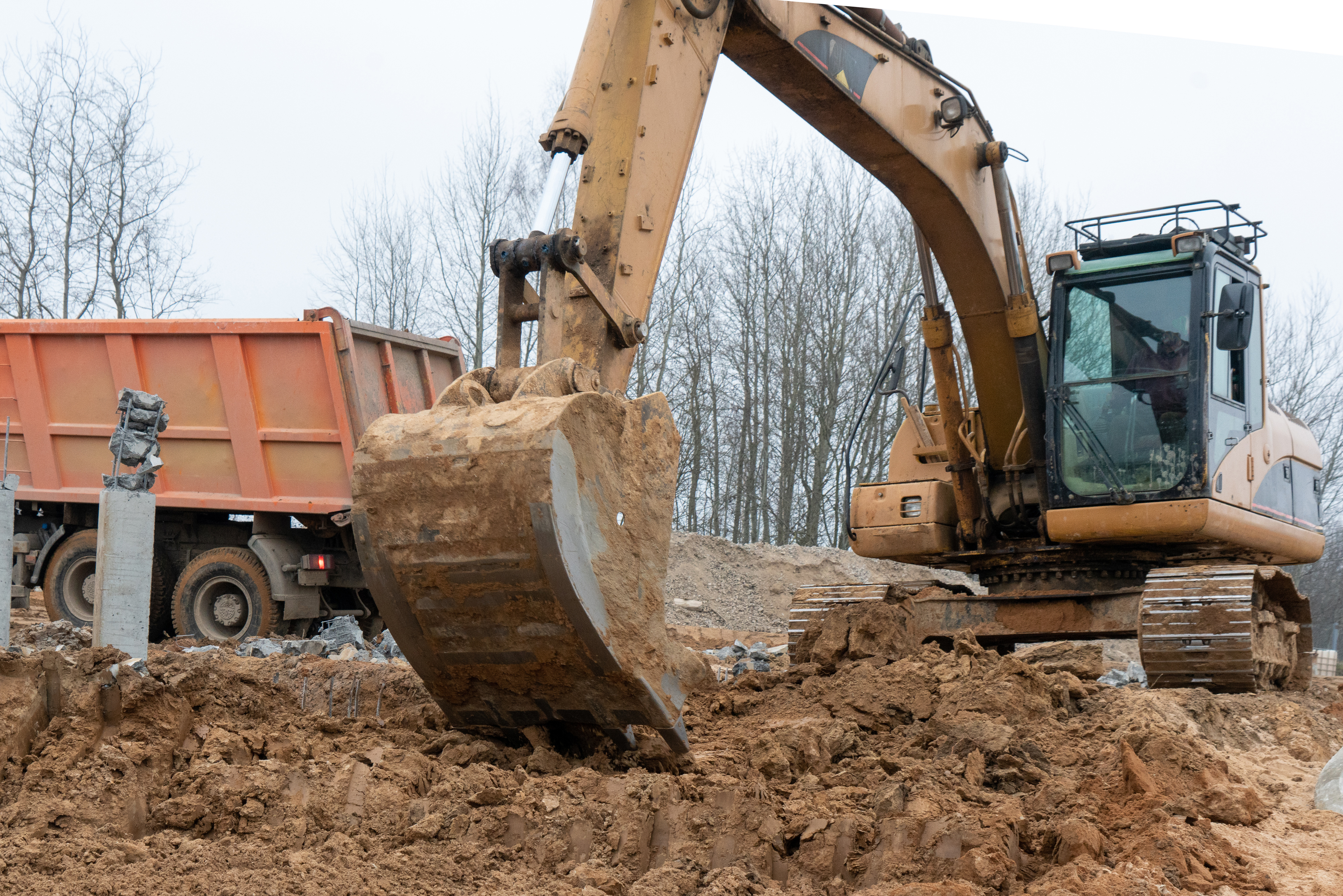 excavator loading a truck