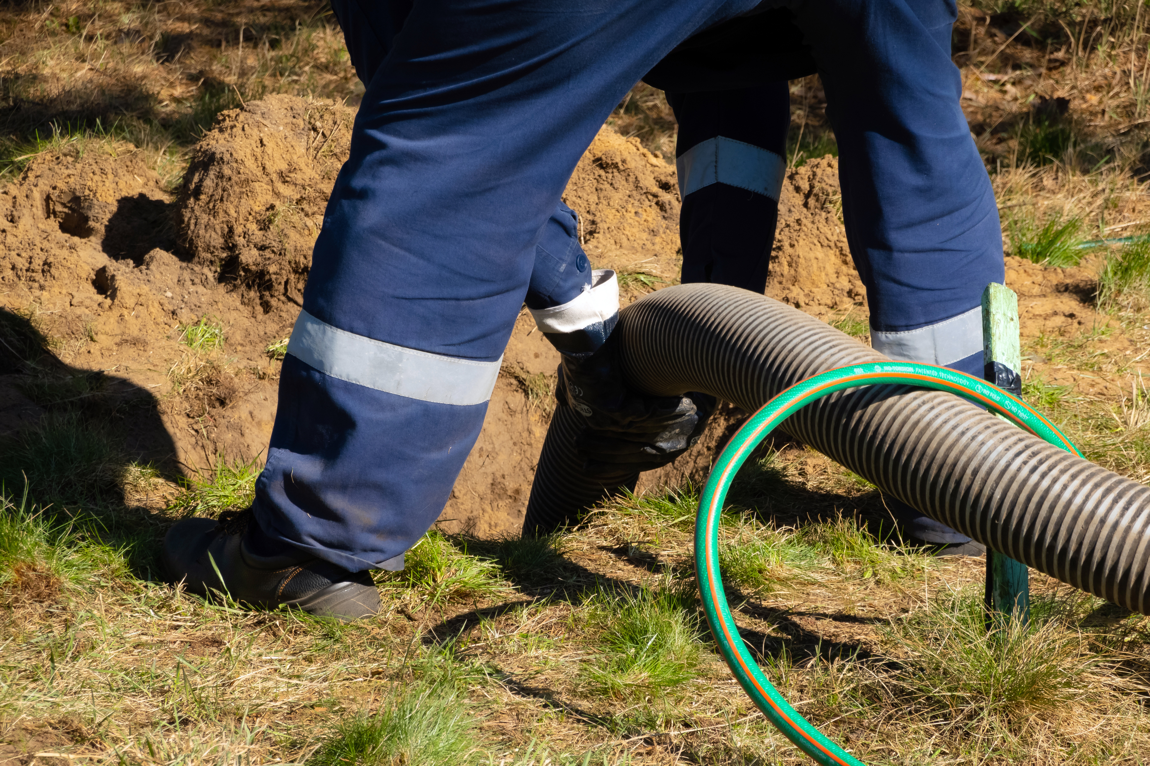 person holding a sewage pipe